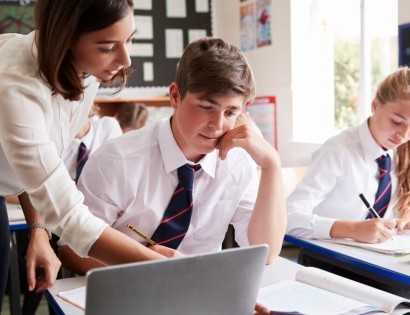 Female teacher helping her pupils 